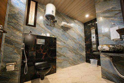 a bathroom with a toilet and a sink at Hotel Dev Vilas 600 Metres from Taj Mahal in Agra