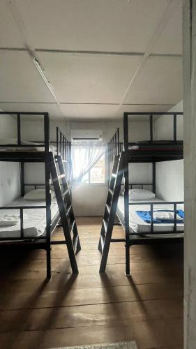 two bunk beds in a room with a window at Baan Yuan in Prachuap Khiri Khan