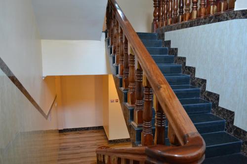 a staircase in a building with blue stairs at Capital Battambang Hotel in Battambang