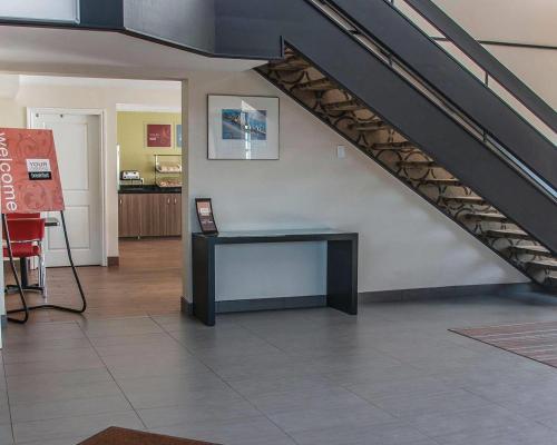 a room with a desk under a stair case at Comfort Inn in Brandon