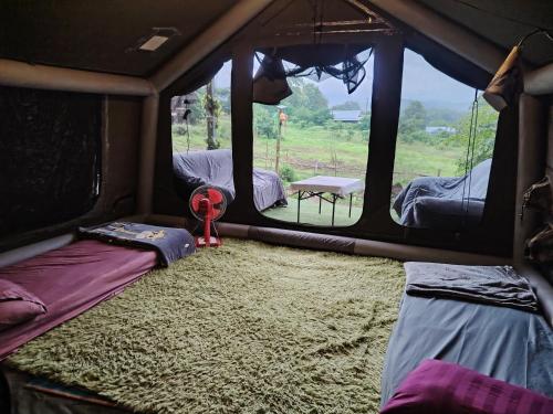 a room with two beds in a tent at Garden de Arts in Pai