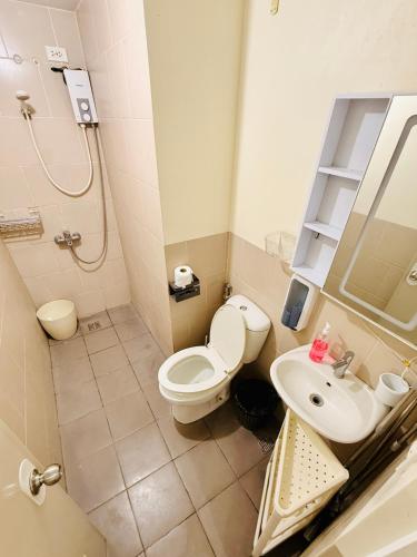 a bathroom with a toilet and a sink at JFam Suites, C4-11K Studio, Up To 4 Pax in Biñan