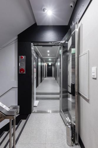 a hallway with an elevator in a building at VIA jongno in Seoul