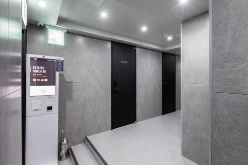 a elevator lobby with two elevators in a building at VIA jongno in Seoul