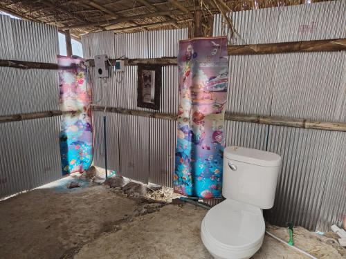 a bathroom with a toilet in a building at Garden de Arts in Pai