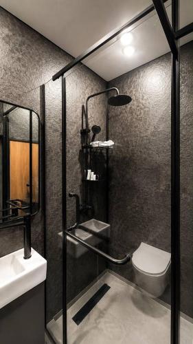 a bathroom with a toilet and a sink at AIRIS Residence in Almaty