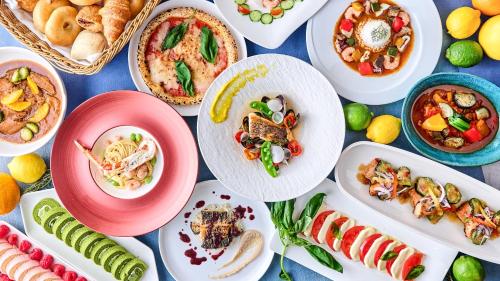 a table full of plates of food on a table at Hotel Trusty Tokyo Bayside in Tokyo