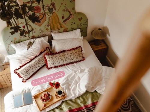 a bed with white sheets and pillows on it at Gorgeous Stylish Home Near Longleat and Bath with Private Heated Pool and Sauna in Corsley