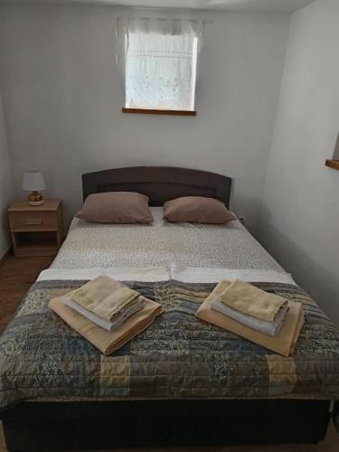 a bedroom with a bed with two towels on it at Apartman Ane - Bribir in Bribir