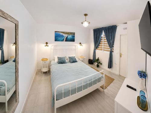 a bedroom with a large bed and a mirror at Casa TEOS in 2 Mai
