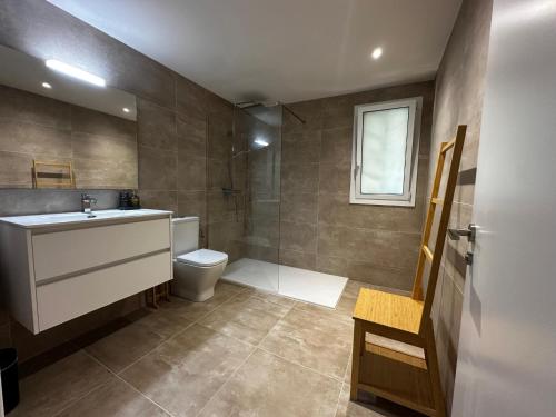 a bathroom with a toilet and a sink and a shower at Villa Las Dos Rocas in Calonge