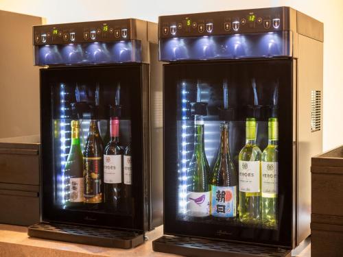 two refrigerators with bottles of alcohol in them at KAMENOI HOTEL Genkainada All-Inclusive Resort in Kitakyushu