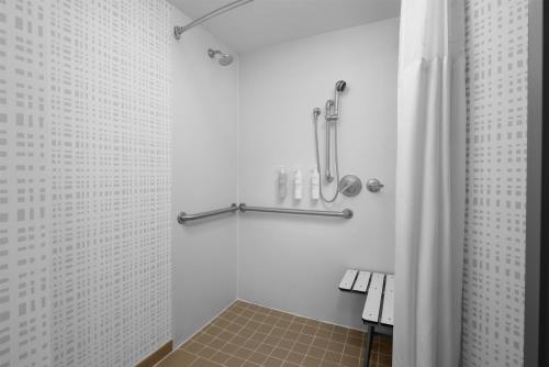 a bathroom with a shower with a shower curtain at Hampton Inn Manhattan Grand Central in New York