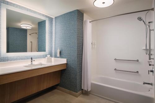 a bathroom with a sink and a tub and a shower at Homewood Suites by Hilton Macon-North in Wesleyan Hills