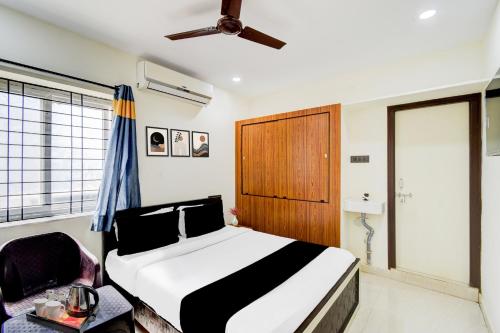 a bedroom with a bed and a ceiling fan at Hotel O SNIST University Hyderabad Formerly Hari Hara Enterprise in Maula Ali