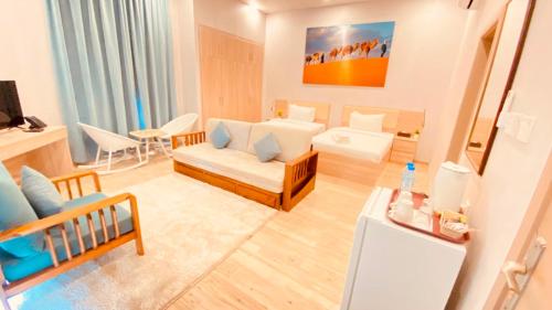 a living room with a couch and a room with at Sugardunes Beach Resort in Ghadw