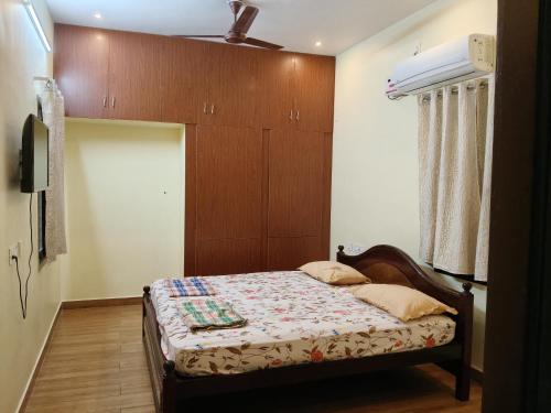 a bedroom with a bed and a ceiling fan at Raja Accommodation in Kovilpatti