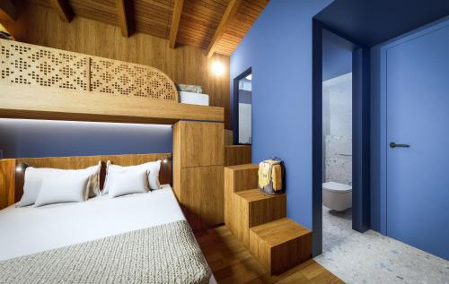 a bedroom with a bunk bed and a bathroom at Olympus Refuge D in Litochoro
