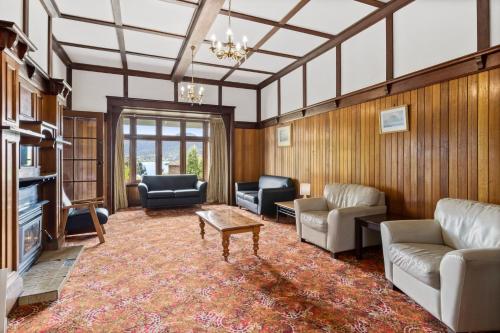a living room with couches and a table at Riverfront Motel & Restaurant in Hobart