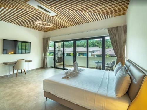 a bedroom with a large bed and a living room at Villa Coco Escape in Ko Phangan