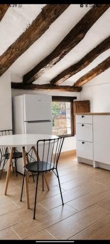 a kitchen with a table and chairs in a room at Origen&Madera in Alcalá del Júcar