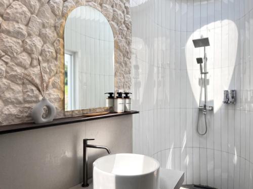 a bathroom with a sink and a mirror at Zatura Dome Glamping in Panjadakan