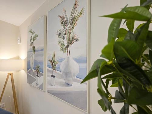 a picture of vases on a wall with plants at LURDE Apartamentos Rurales in El Cerezal