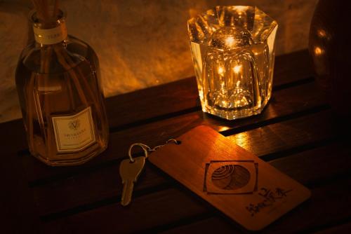 a bottle of wine and a key on a table at Hakone Kairai in Hakone