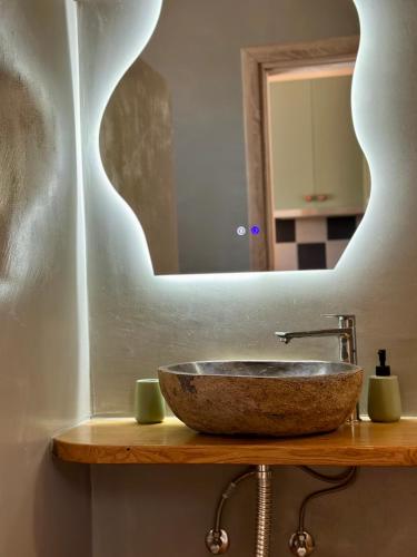 a bathroom with a stone sink and a mirror at Olive Haven in Provatas