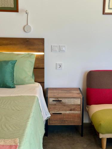 a bedroom with a bed and a chair and a table at Olive Haven in Provatas