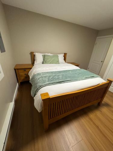 a bedroom with a large bed with a wooden floor at Hope Sunshine Valley Scenic Mountain View House 3BR 3Bath in Hope