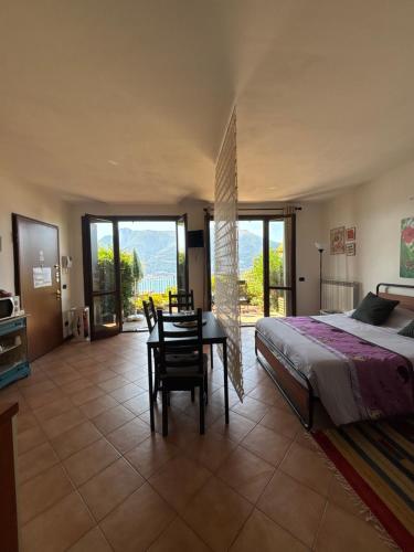 a bedroom with a bed and a table and chairs at residenza gelsomino - relax and view in Bellano