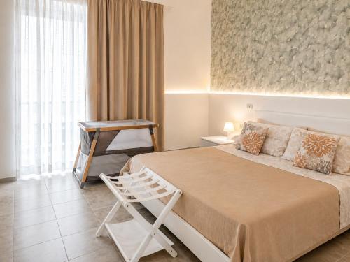 a bedroom with a bed and a chair and a window at Il Verde Rifugio in San Lorenzo