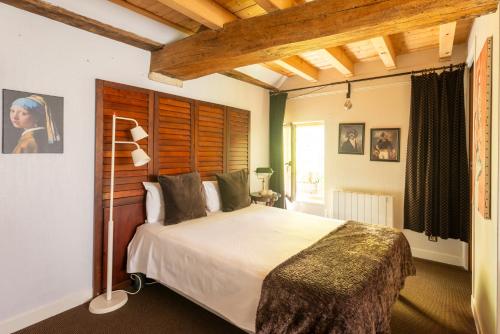 a bedroom with a large bed in a room at La petite maison CARRÉ in Talant