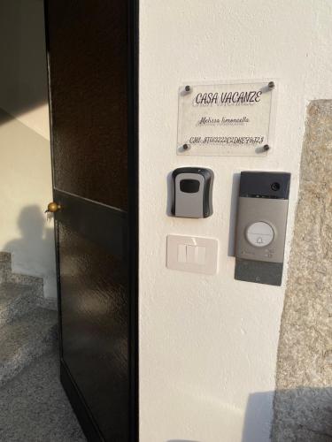 a wall with a sign that reads guest wiimote and an outlet at Casa MELISSA LIMONCELLA , free parking-self check in in Tavernerio