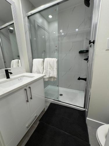 a white bathroom with a shower and a sink at Hope Sunshine Valley Scenic Mountain View House 3BR 3Bath in Hope