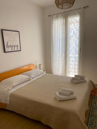 a bedroom with a large bed with two towels on it at Casa Mamà in Marzamemi