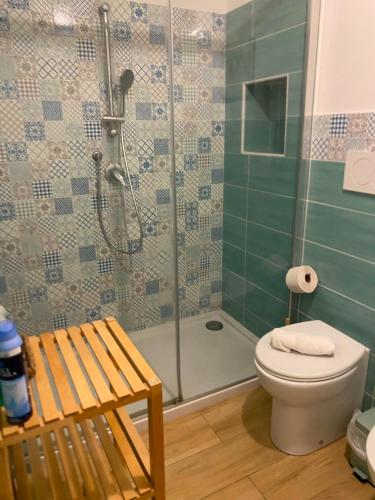 a bathroom with a shower with a toilet and a glass shower at Casa Mamà in Marzamemi