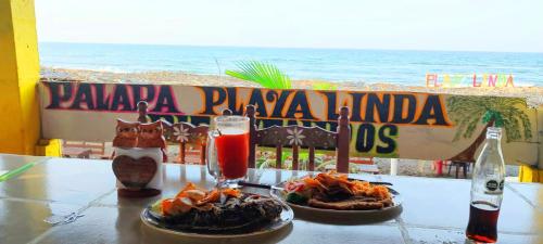 a table with two plates of food and a drink at Casa de Descanso - Camelia in Monte Gordo