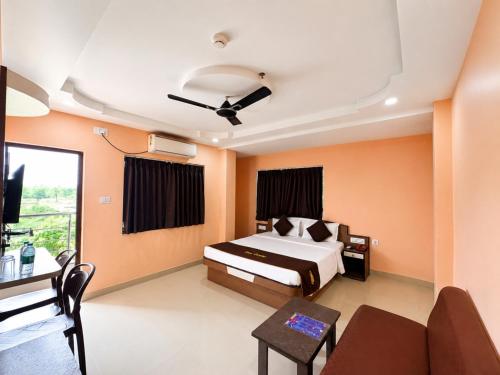 a bedroom with a bed and a couch at Hotel The Four Square in Digha