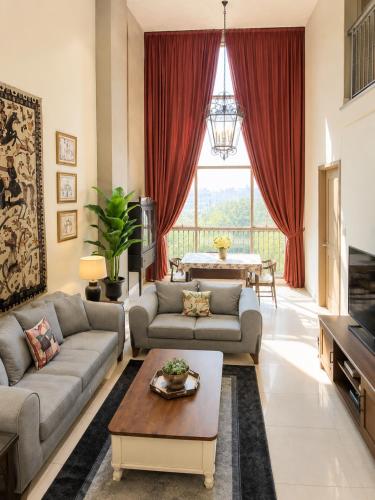 a living room with two couches and a table at SkyHouse by Ace Luxe in Islamabad