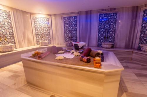 a room with a table in a room with stained glass windows at Business Life Hotel & SPA Bakırköy in Istanbul