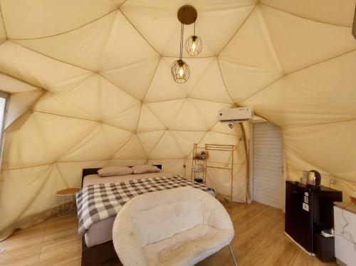 a room with a bed in a large tent at Maple Dome Glamping in Bandung