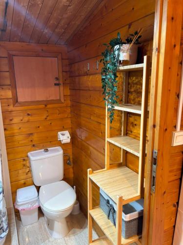 a bathroom with a toilet in a wooden cabin at Camping Torremolinos in Torremolinos