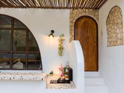 an entry to a house with a door and a counter at Hanara Bohemian Villa in Bandung