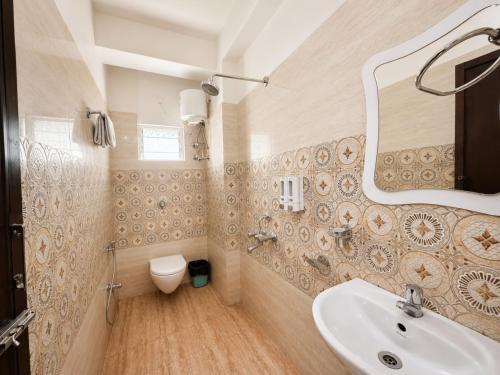 a bathroom with a sink and a toilet at Hotel The Four Square in Digha