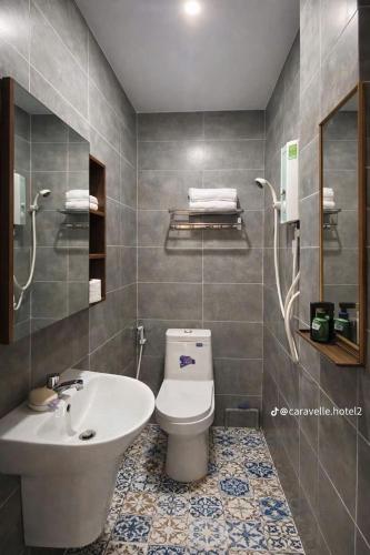 a bathroom with a toilet and a sink at Khách sạn Caravelle Cần Thơ 2 in Can Tho