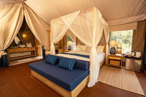 a bedroom with a canopy bed in a tent at Visama Explorer Nan in Ban Huai Luk