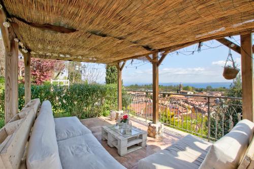 a patio with a couch and a table at Agriturismo Cascina Crocelle - Lake View and Heated Pool in Padenghe sul Garda