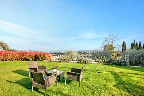 a table and chairs on a grass field at Agriturismo Cascina Crocelle - Lake View and Heated Pool in Padenghe sul Garda